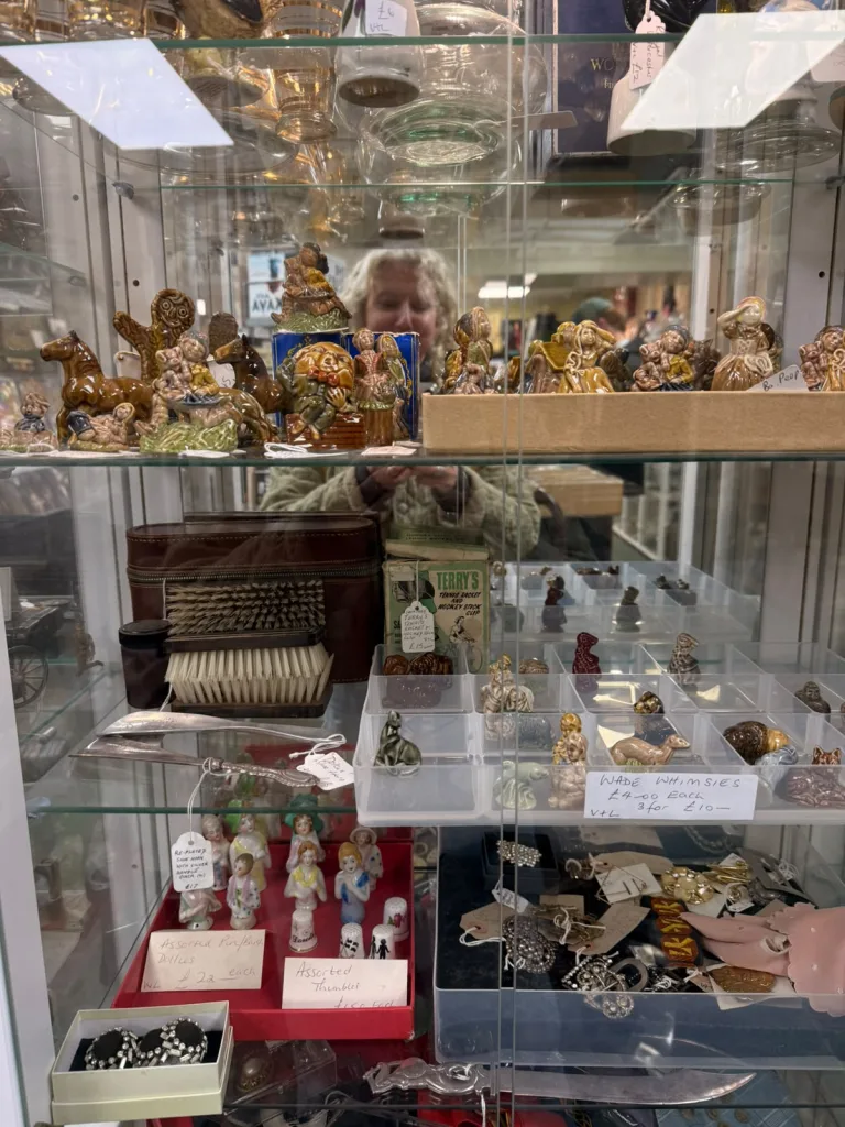 Glass cabinet of vintage costume dolls at Antiques on High, Bowness