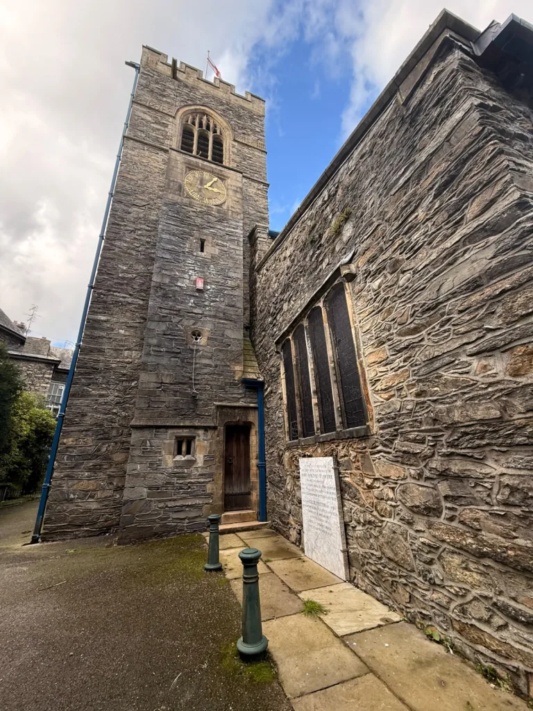 St Martin's Church tower with John Bolton's white marble memorial stone
